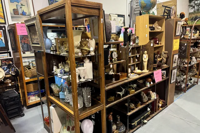 Tall wooden and glass display cabinets filled with figurines and glassware