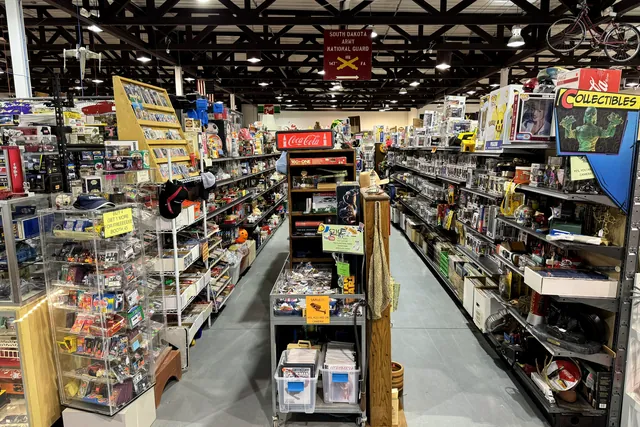A long aisle of shelving beneath a Collectibles sign