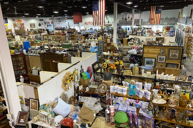 Booths of furniture and collectibles stretching away under the flags