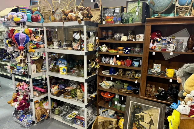 Shelves of plush toys, baskets, globes and bric-a-brac
