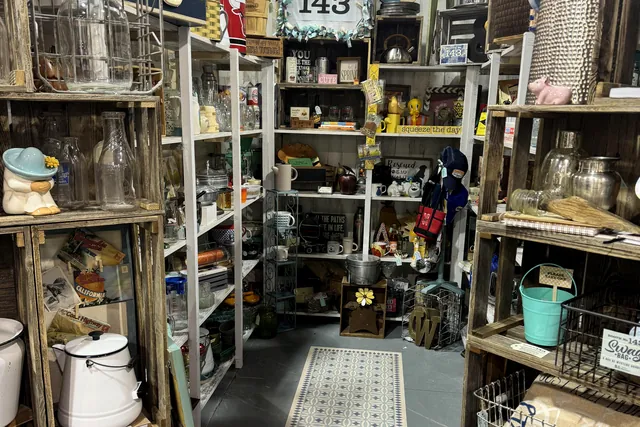 Shelving and baskets filling a booth along the aisle
