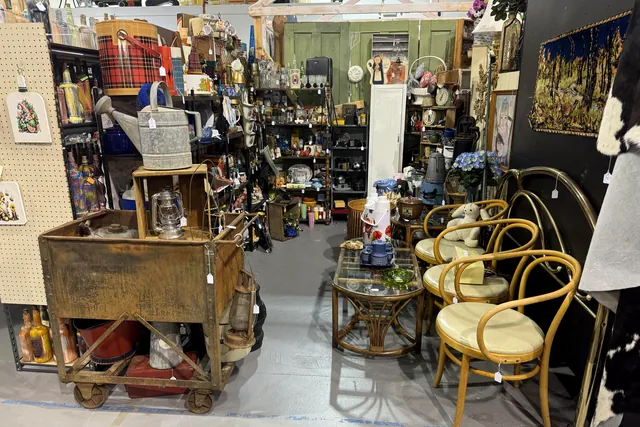 Bentwood chairs and a lantern beside an old wooden cart