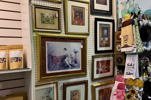 A wall hung with framed prints and paintings of every size